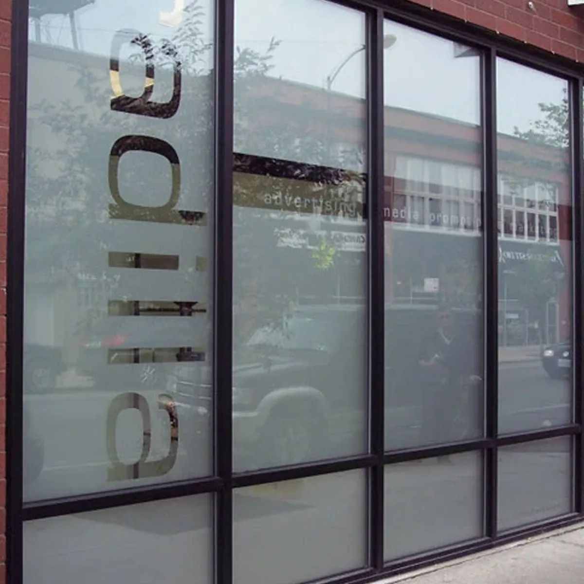 Frosted glass with a clear company logo left in the glass